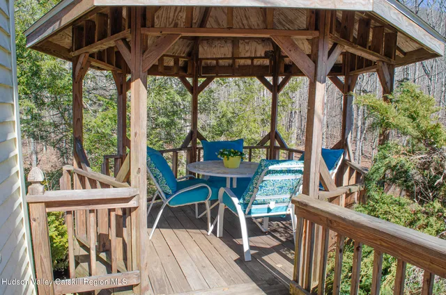 a view of a chairs and table in the balcony