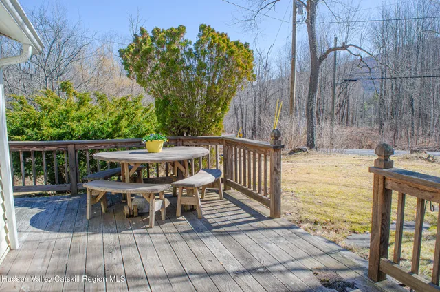 a view of balcony with wooden floor and outdoor seating