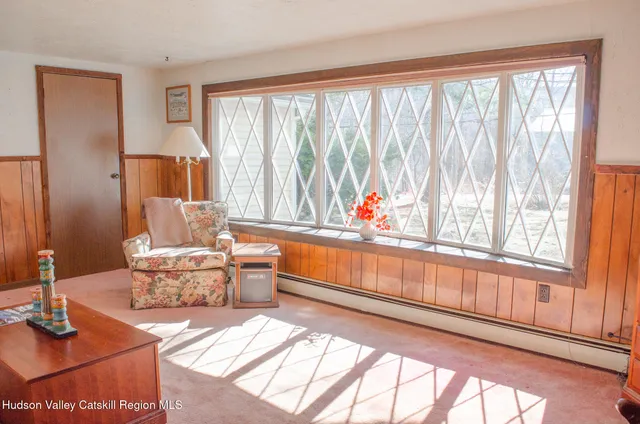 a living room with furniture and large windows