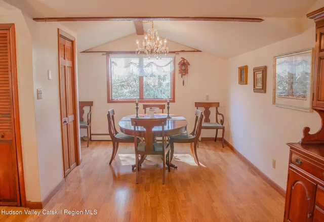 a view of a dining room with furniture wooden floor and chandelier