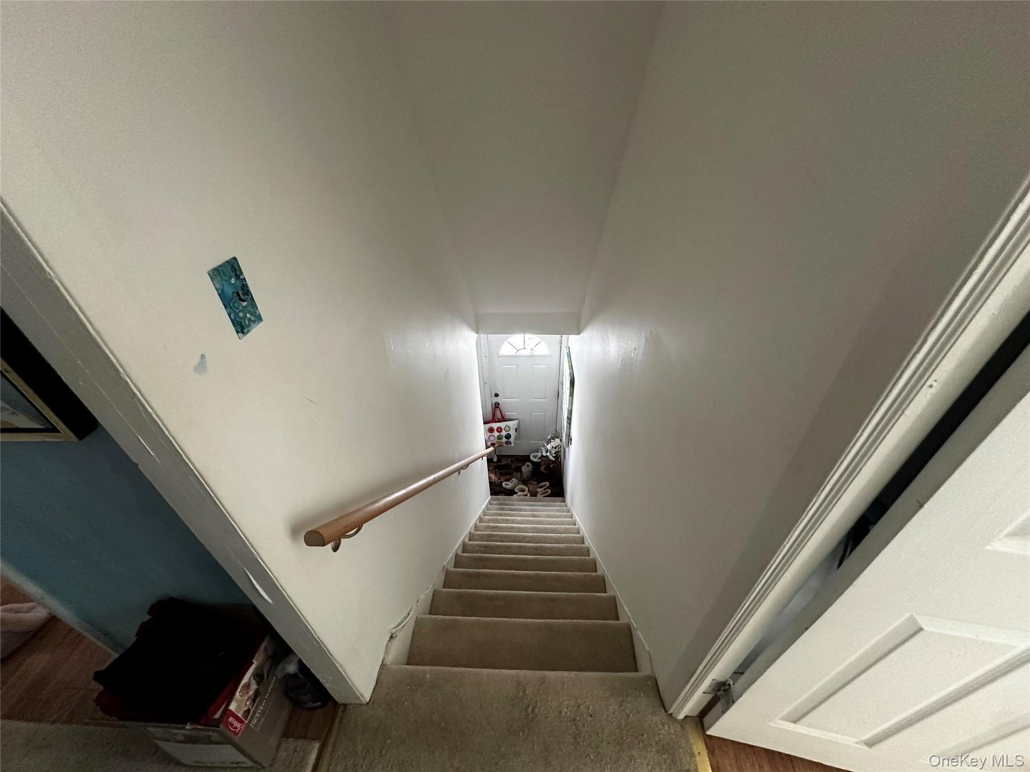 241-16 148th Road Queens, NY 11422 - Photo 16 of 28 a view of a hallway with wooden floor and stairs