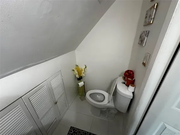 a bathroom with a toilet a sink and a mirror