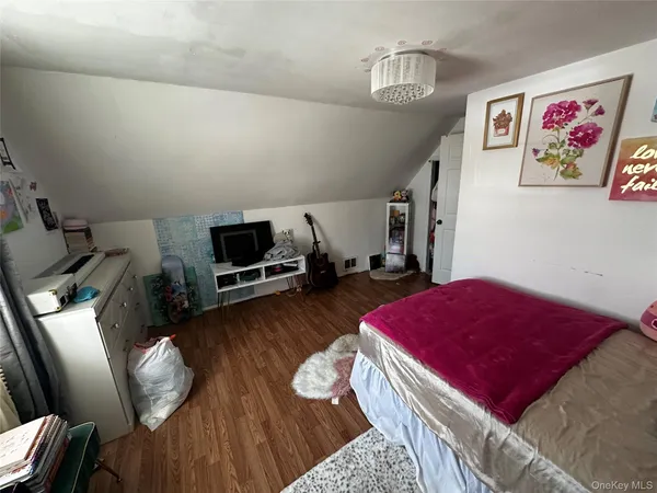 a bedroom with furniture and wooden floor