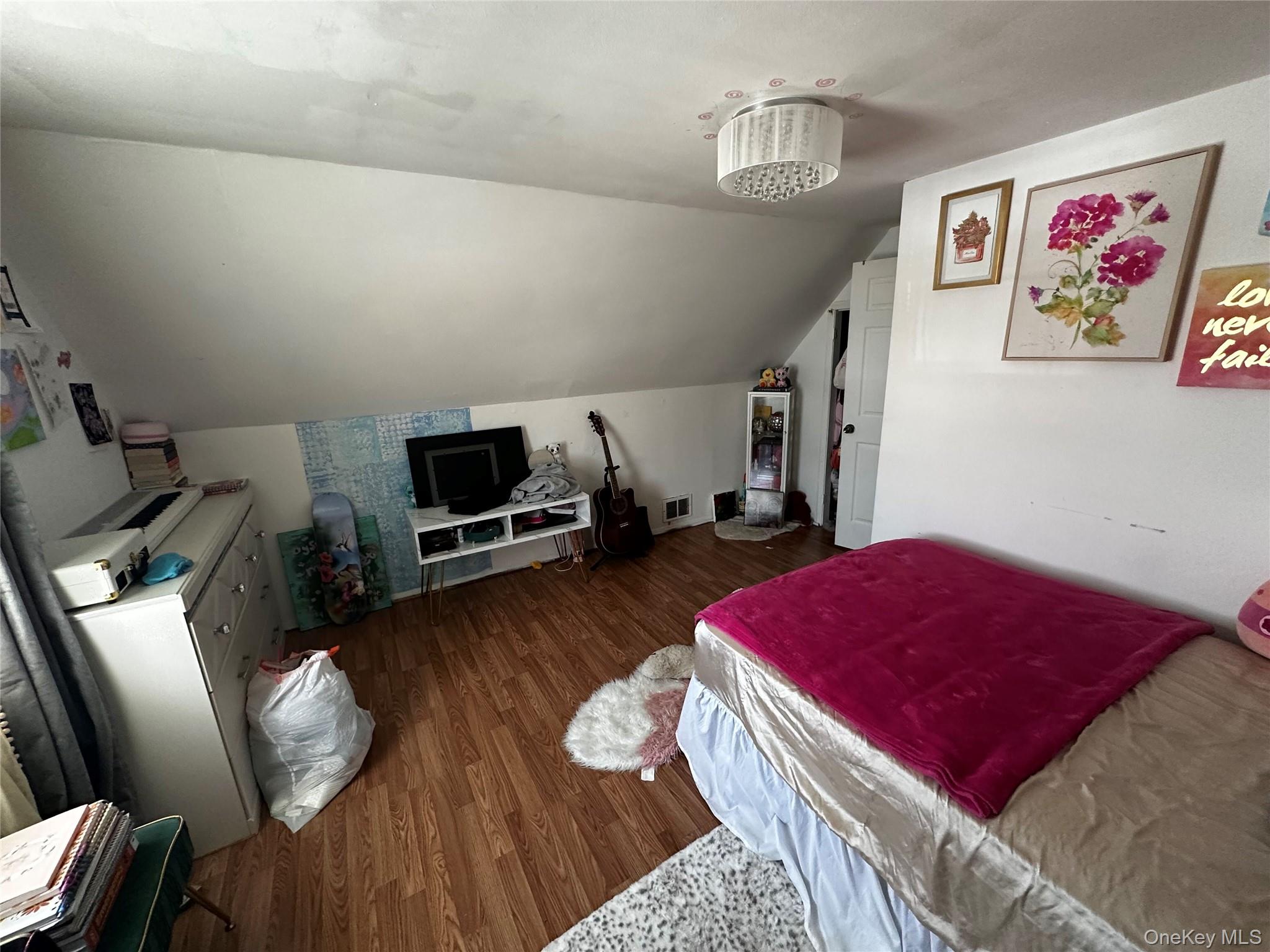 241-16 148th Road Queens, NY 11422 - Photo 21 of 28 a living room with furniture and a wooden floor