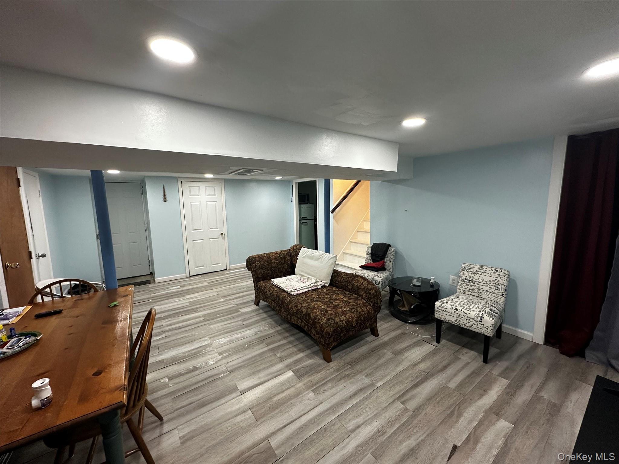 241-16 148th Road Queens, NY 11422 - Photo 25 of 28 a living room with furniture and a wooden floor