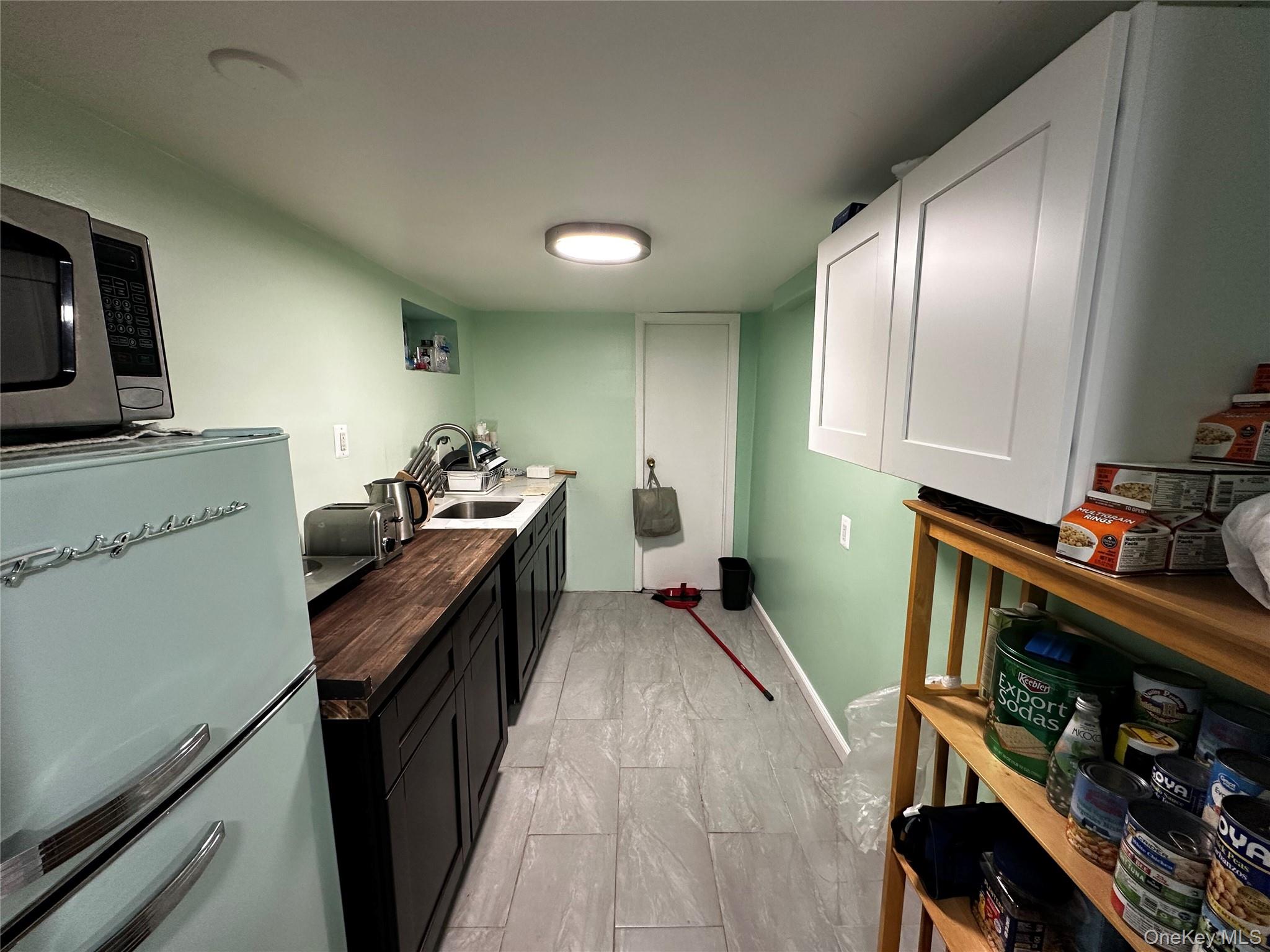 241-16 148th Road Queens, NY 11422 - Photo 26 of 28 a kitchen with granite countertop lots of counter top space
