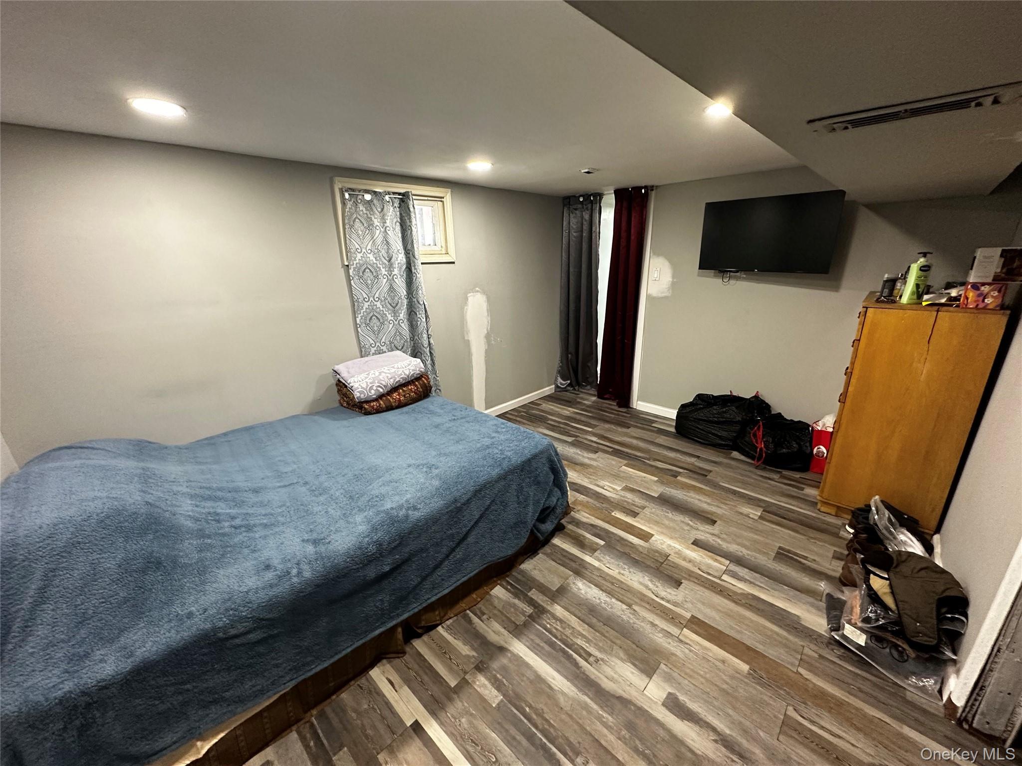 241-16 148th Road Queens, NY 11422 - Photo 28 of 28 a bedroom with a bed and a flat screen tv