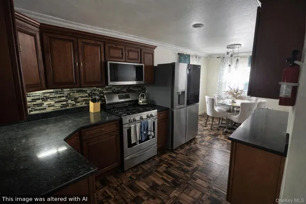 a kitchen with stainless steel appliances granite countertop a stove refrigerator and microwave