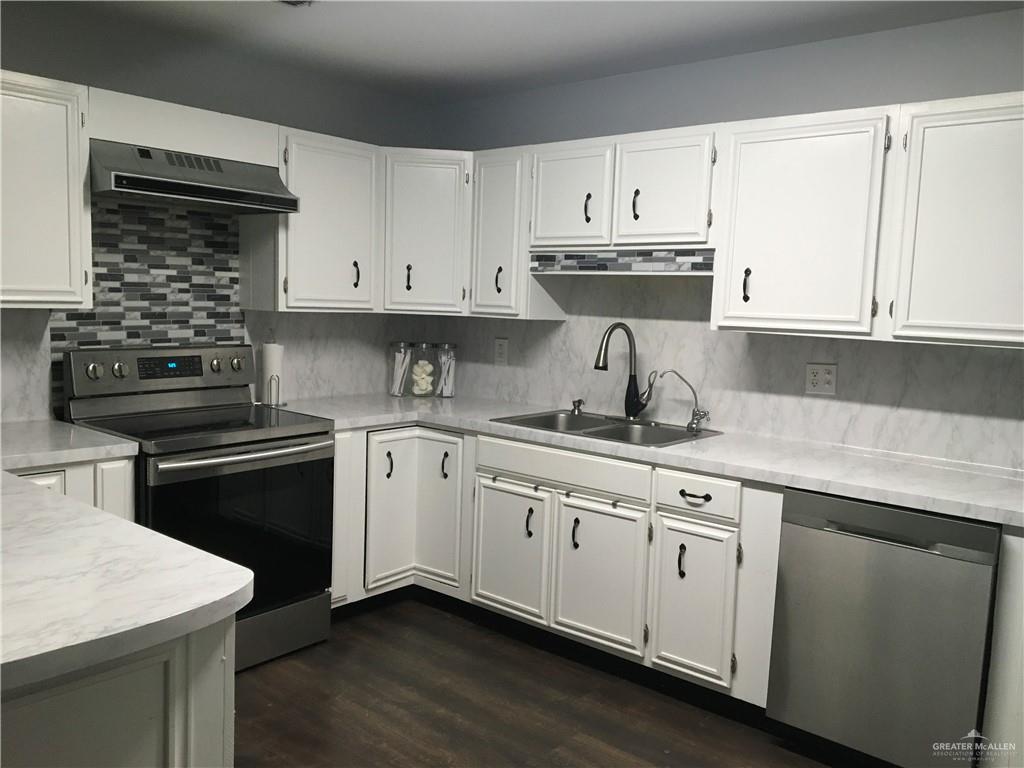 700 Fern Street, Unit 4 McAllen, TX 78504 - Photo 9 of 14 a kitchen with cabinets appliances a sink and a counter