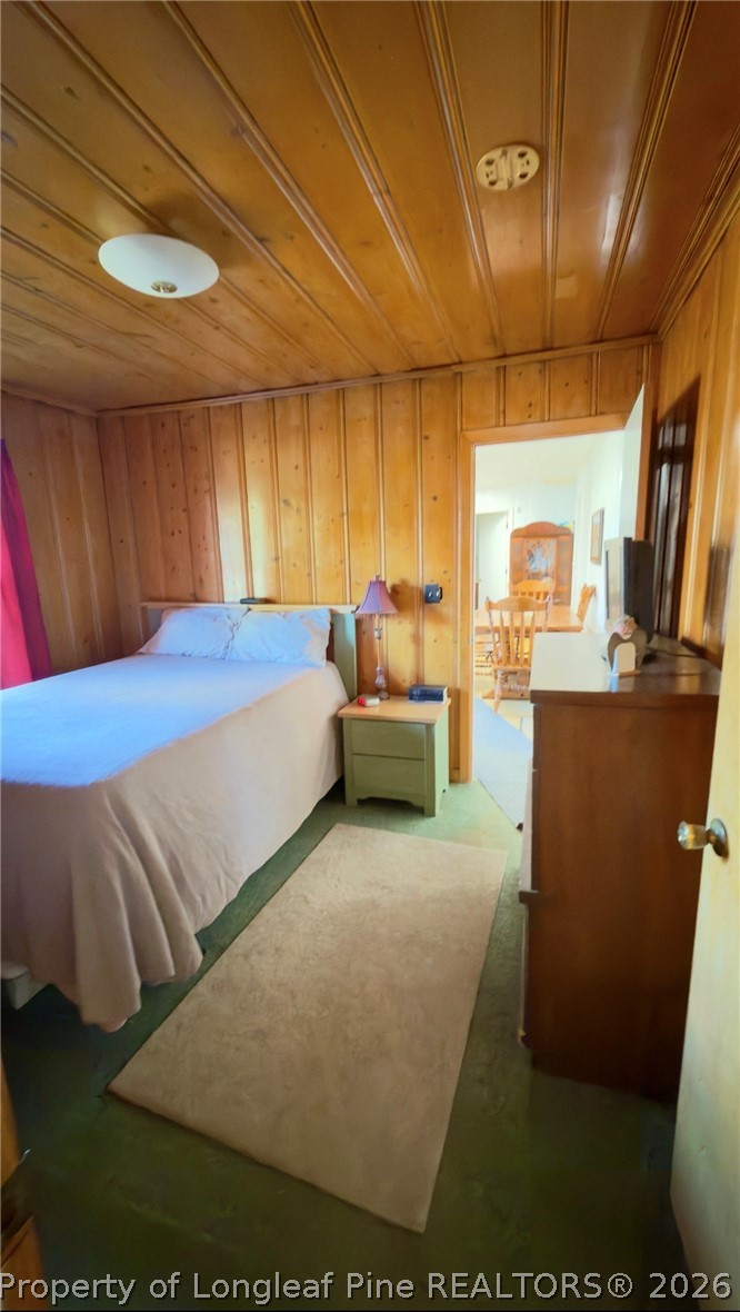 5309 Tobacco Road Orrum, NC 28369 - Photo 15 of 44 a bedroom with a bed and wooden cabinets