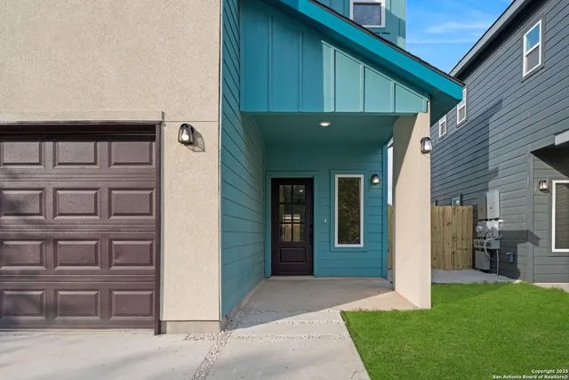 a view of a hallway with wooden floor and a bathroom