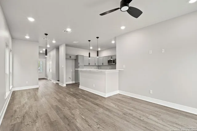 a kitchen with cabinets appliances a sink and a counter top space