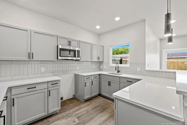 a kitchen with a sink stove and microwave