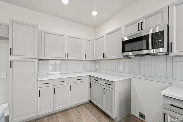 a view of an empty room with a window and a ceiling fan