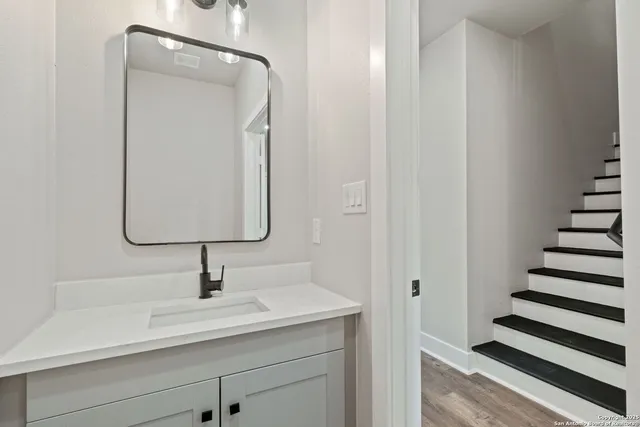 a large kitchen with stainless steel appliances granite countertop a sink a stove a microwave a center island and cabinets