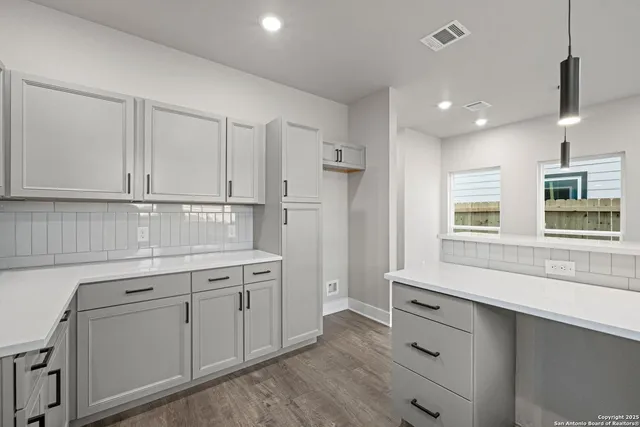 a bathroom with a double vanity sink a large mirror and a bathtub