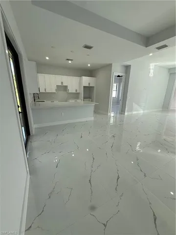 a spacious bathroom with a double vanity sink a mirror and a shower