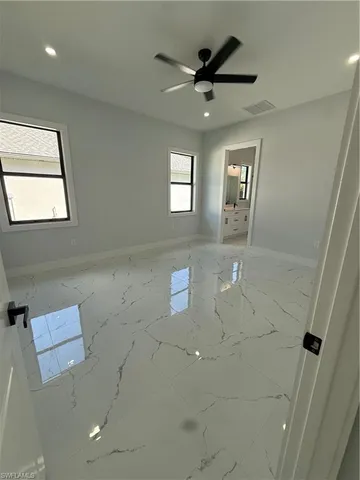 en empty room with window and ceiling fan