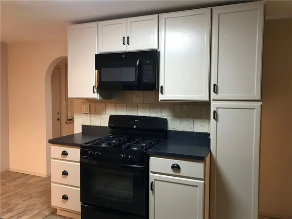 a kitchen with a stove microwave and sink