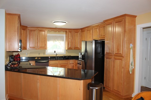 11 Dillard Road Forsyth, GA 31029 - Photo 5 of 14 a kitchen with stainless steel appliances granite countertop a refrigerator a stove and a sink with wooden floor