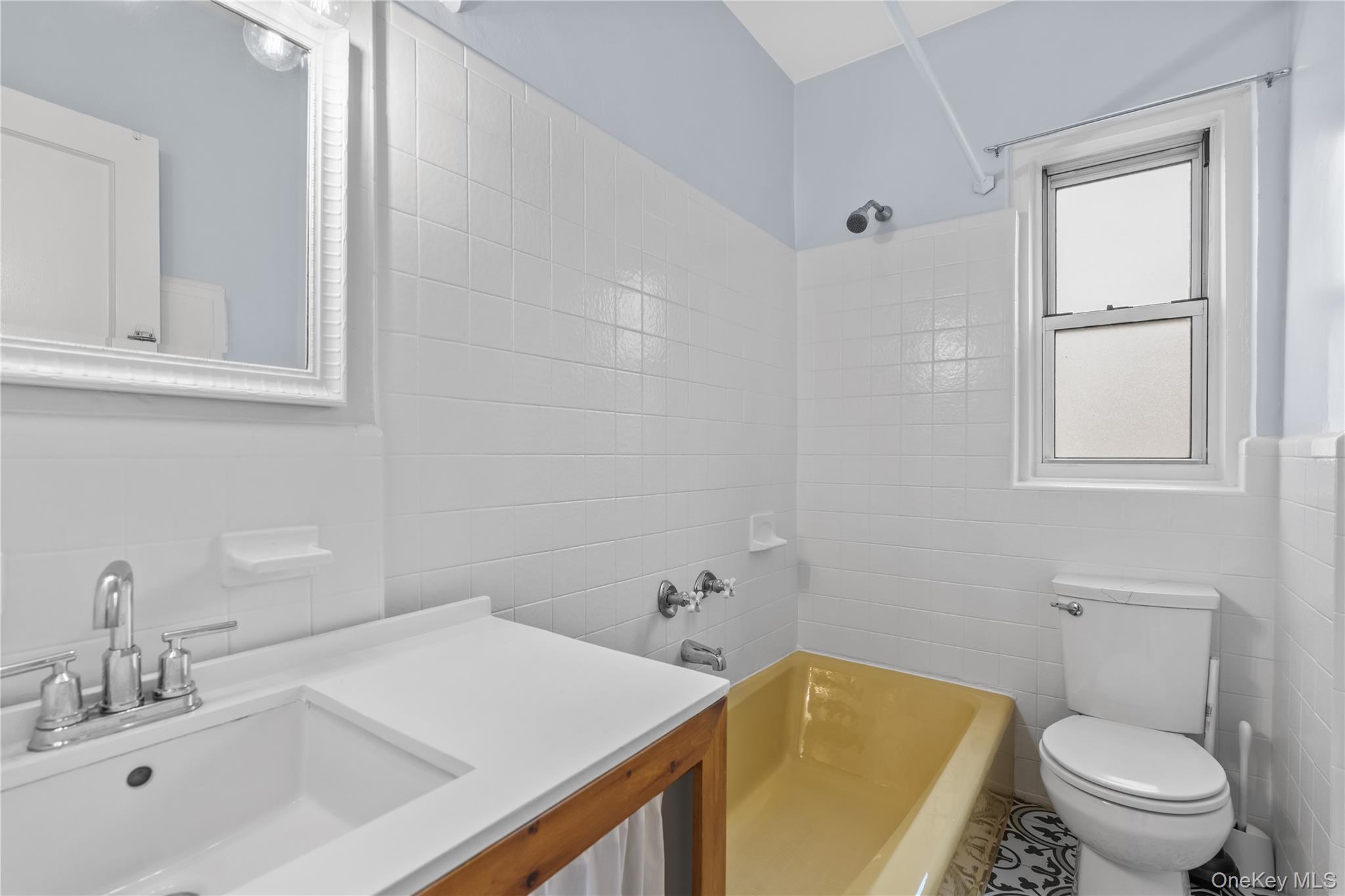 822 Palmer Road, Unit 3B Bronxville, NY 10708 - Photo 13 of 19 a bathroom with a sink a toilet and shower