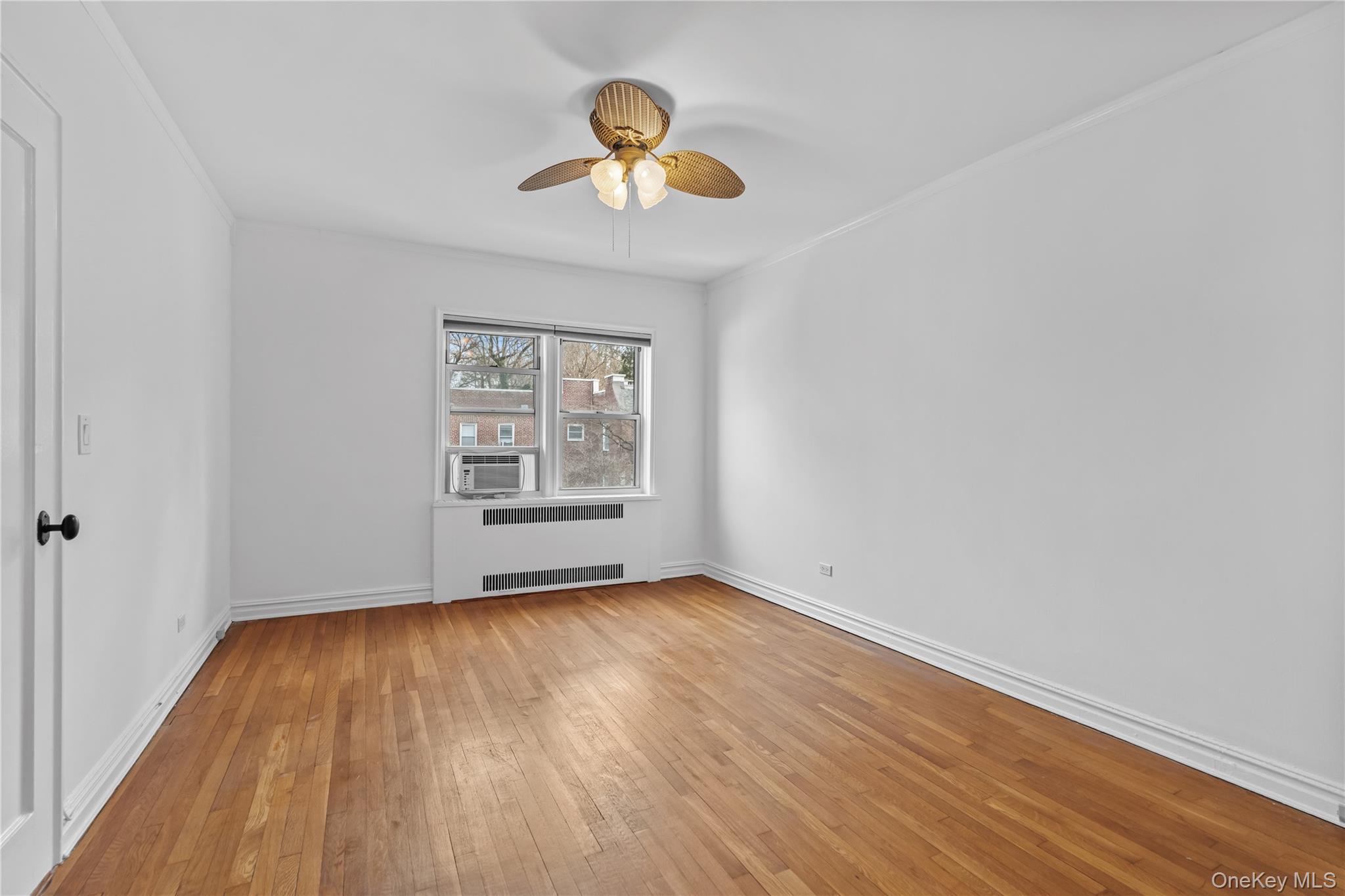 822 Palmer Road, Unit 3B Bronxville, NY 10708 - Photo 14 of 19 an empty room with wooden floor and windows