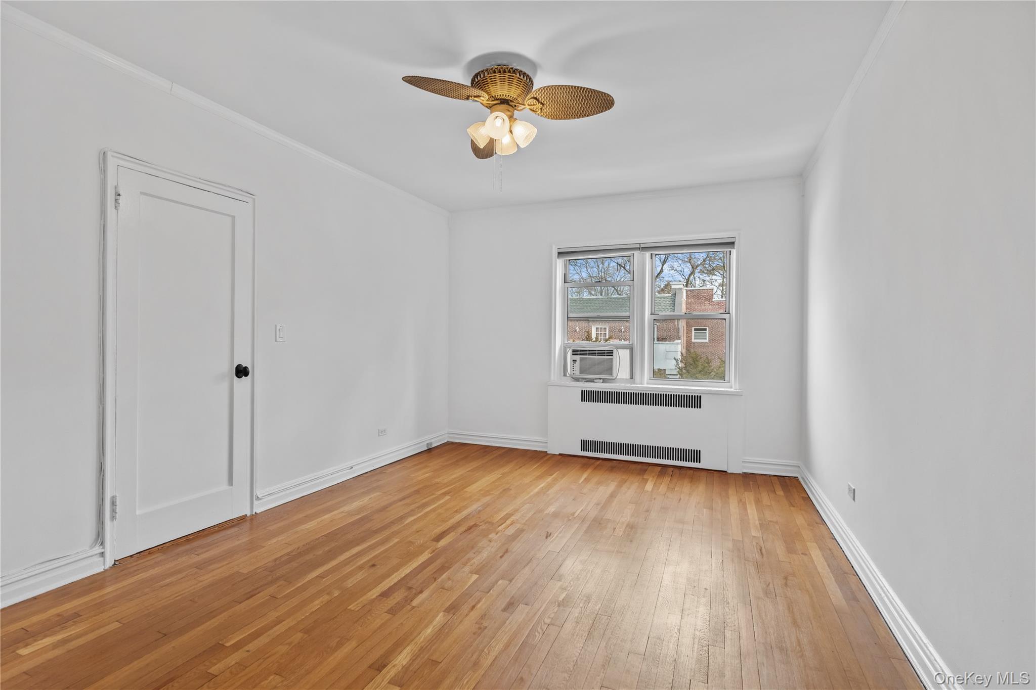 822 Palmer Road, Unit 3B Bronxville, NY 10708 - Photo 15 of 19 a view of an empty room with wooden floor and a window