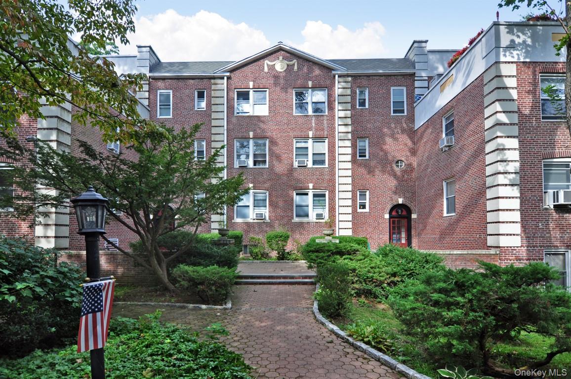 822 Palmer Road, Unit 3B Bronxville, NY 10708 - Photo 16 of 19 a view of a brick building next to a yard