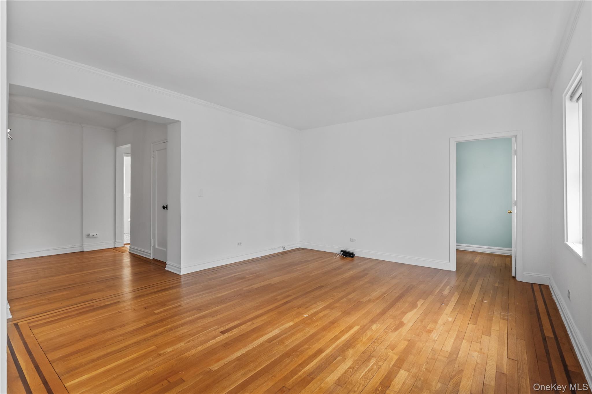 822 Palmer Road, Unit 3B Bronxville, NY 10708 - Photo 5 of 19 wooden floor in a hall with an empty room