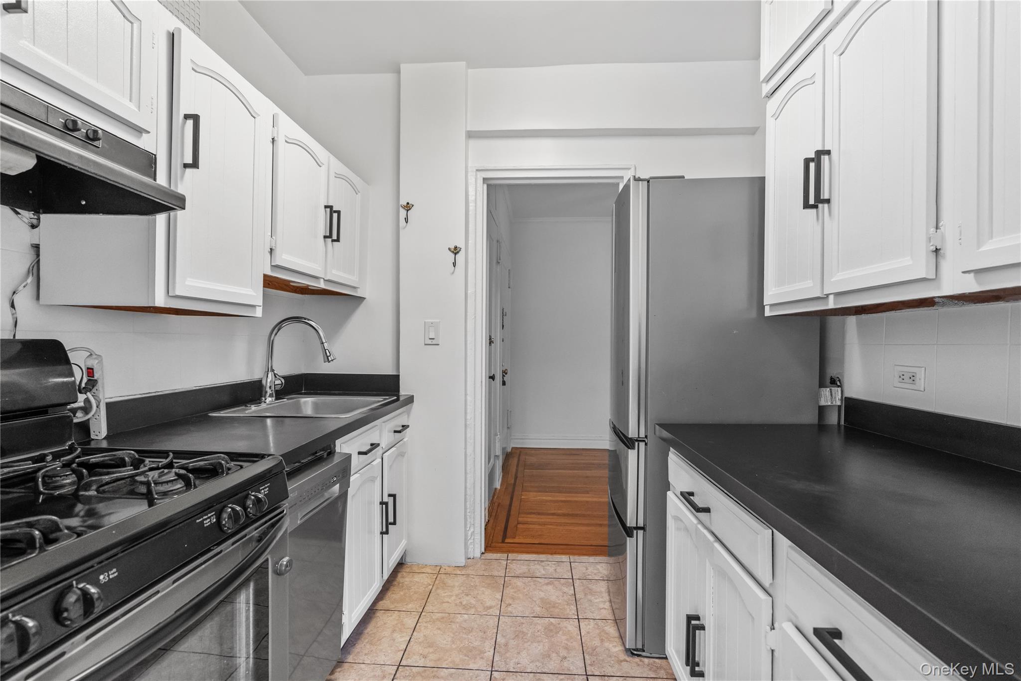 822 Palmer Road, Unit 3B Bronxville, NY 10708 - Photo 7 of 19 a kitchen with granite countertop a stove and a sink