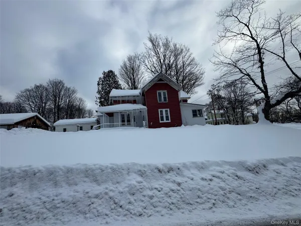 a view of a house with a snow in the yard