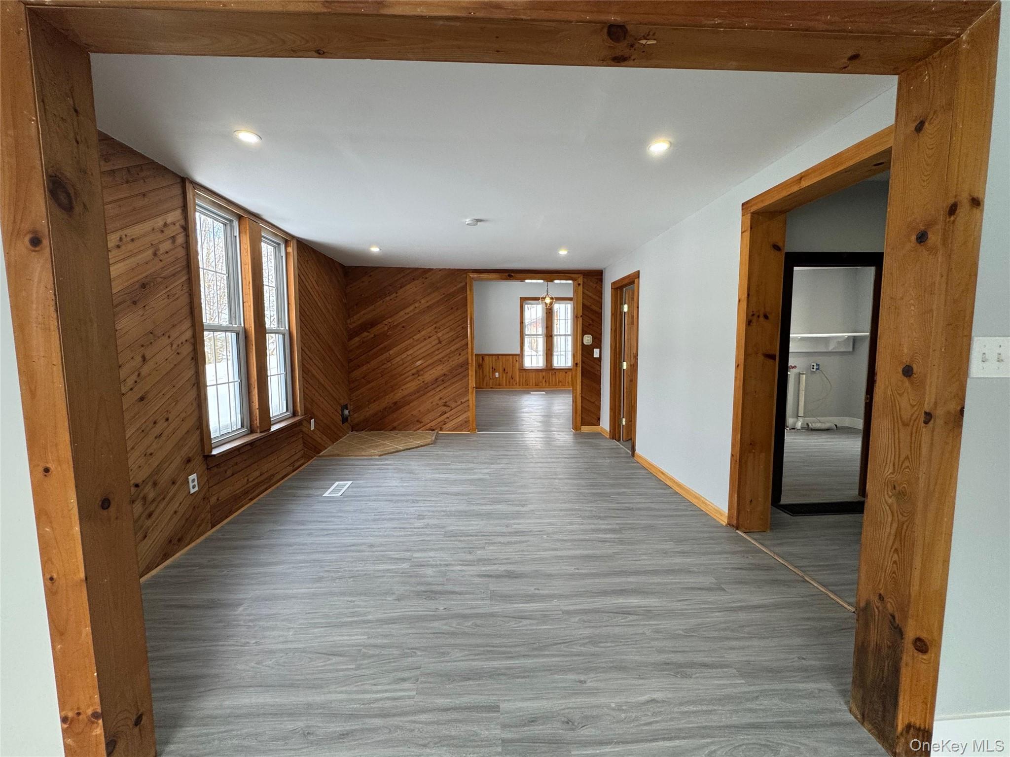 9606 Lincoln Avenue Remsen, NY 13438 - Photo 21 of 43 Unfurnished living room featuring wood walls, wood finished floors, and recessed lighting