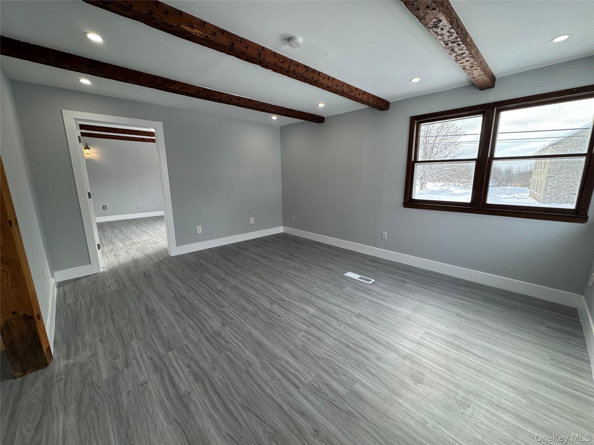 9606 Lincoln Avenue Remsen, NY 13438 - Photo 22 of 43 Unfurnished room with beamed ceiling, recessed lighting, and dark wood-style flooring