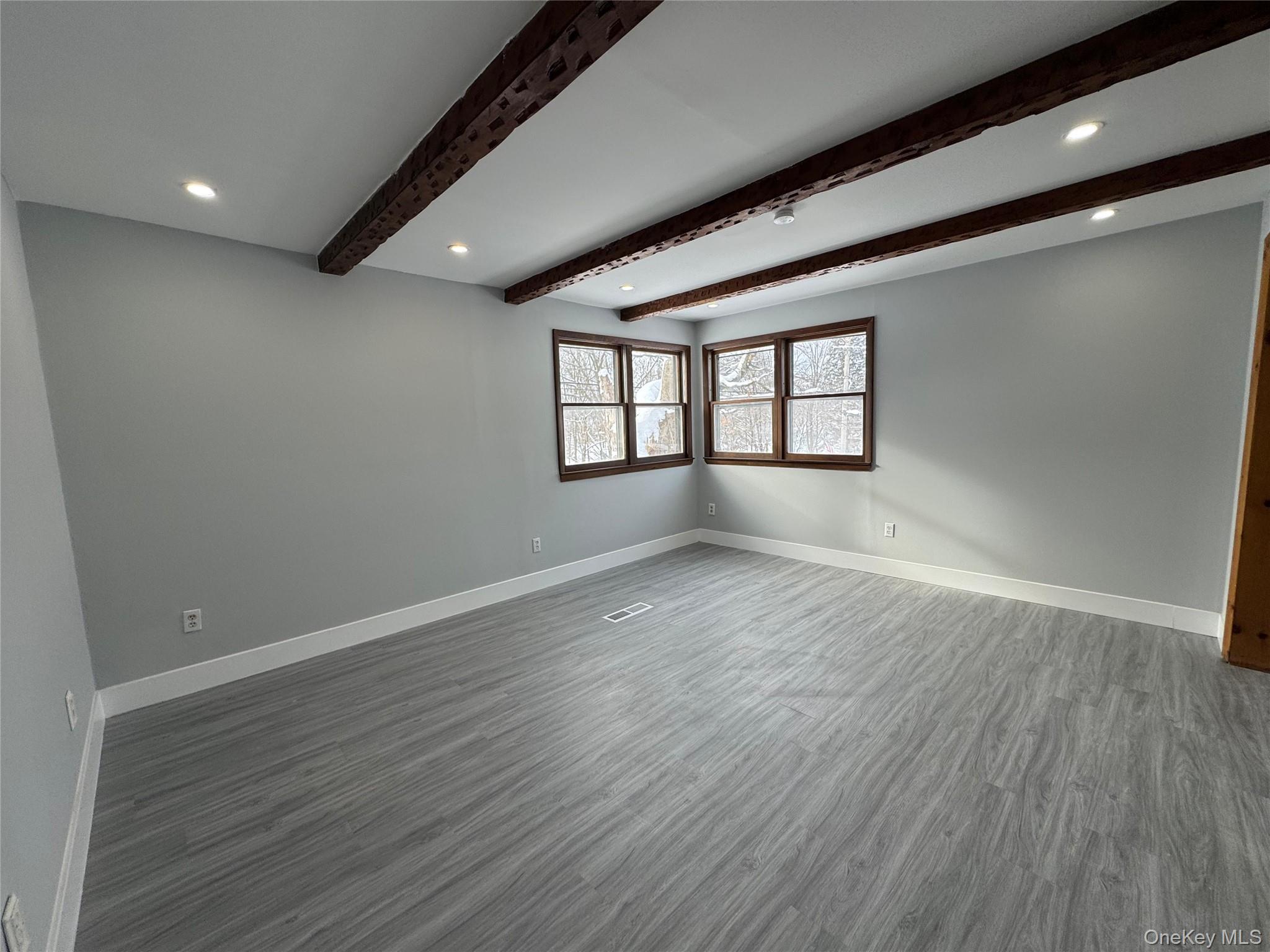 9606 Lincoln Avenue Remsen, NY 13438 - Photo 25 of 43 Spare room featuring recessed lighting, dark wood-style flooring, and beam ceiling