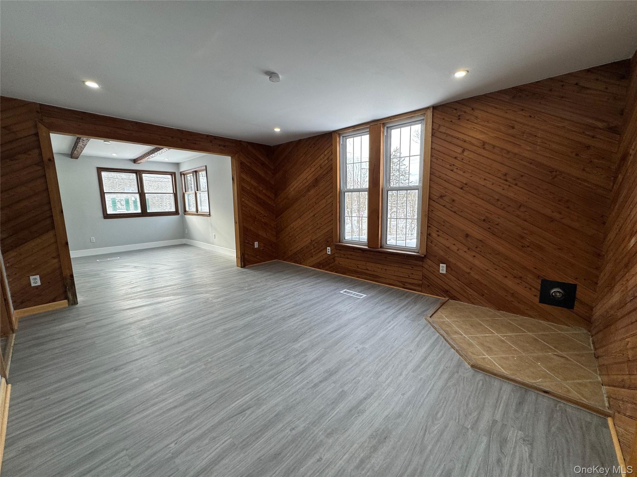 9606 Lincoln Avenue Remsen, NY 13438 - Photo 27 of 43 Unfurnished living room with wooden walls, wood finished floors, and recessed lighting