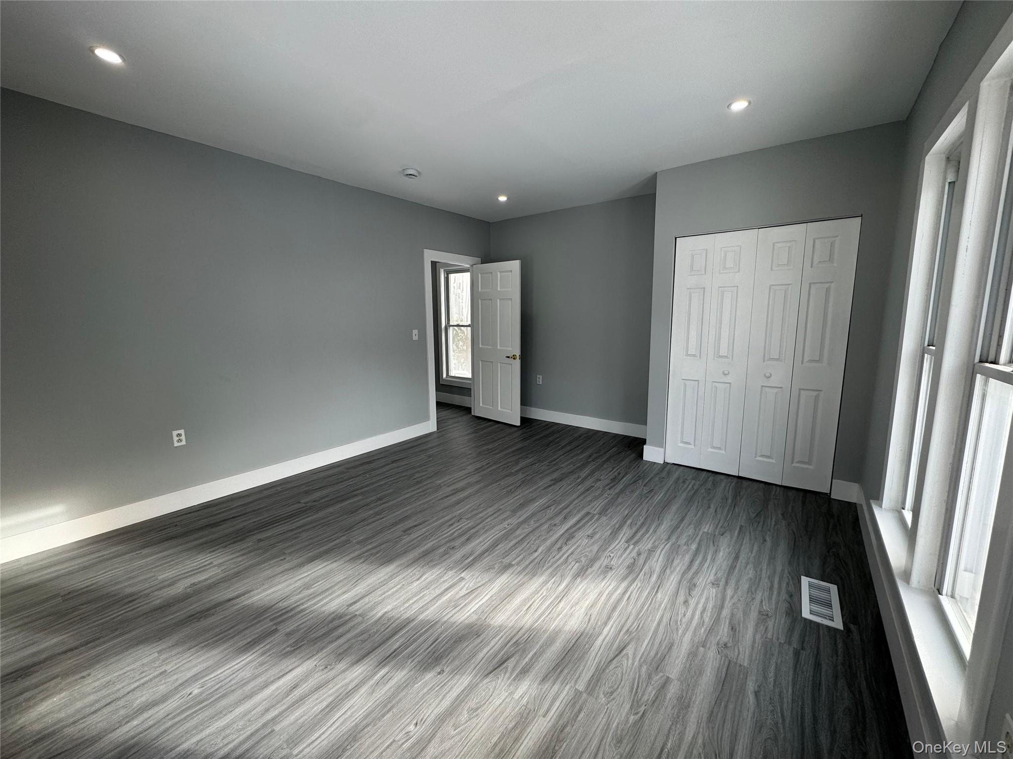 9606 Lincoln Avenue Remsen, NY 13438 - Photo 36 of 43 Unfurnished bedroom with dark wood-style flooring, recessed lighting, and a closet