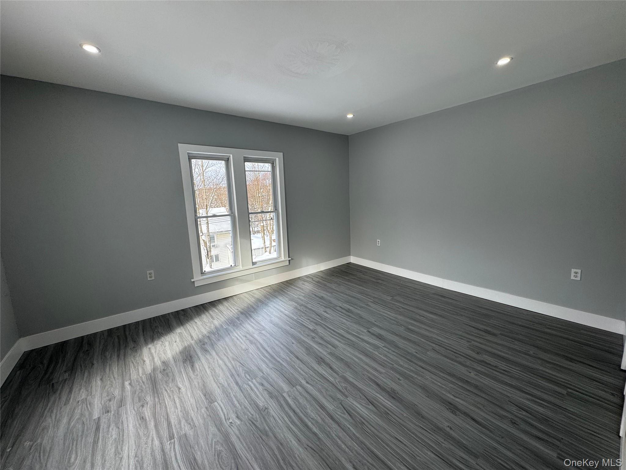 9606 Lincoln Avenue Remsen, NY 13438 - Photo 42 of 47 an empty room with wooden floor and windows