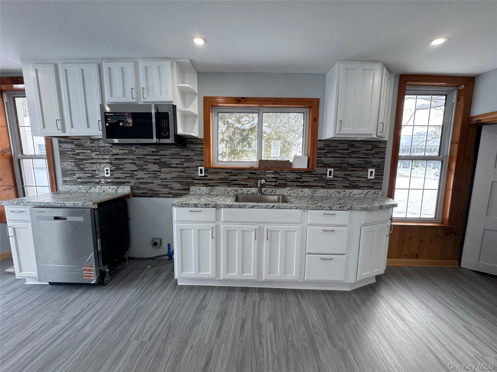 9606 Lincoln Avenue Remsen, NY 13438 - Photo 8 of 47 a kitchen with stainless steel appliances granite countertop wooden cabinets and a granite counter tops
