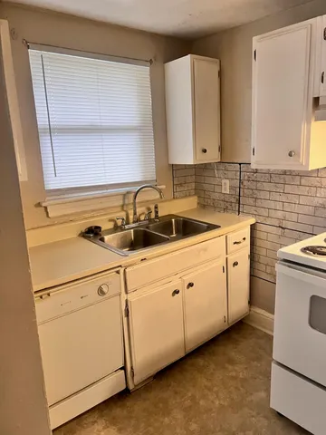 a kitchen with sink and cabinets