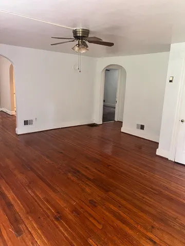 a view of a room with wooden floor