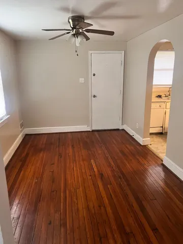 a view of a room with wooden floor and a window