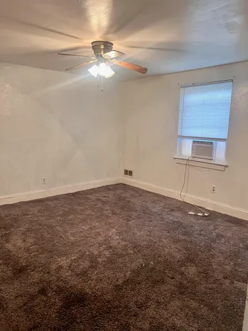 an empty room with a empty space and windows