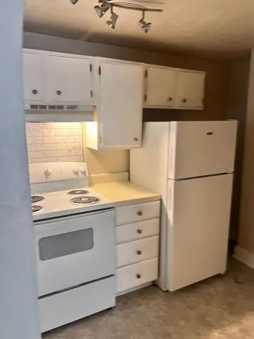 a kitchen with cabinets appliances and a counter top
