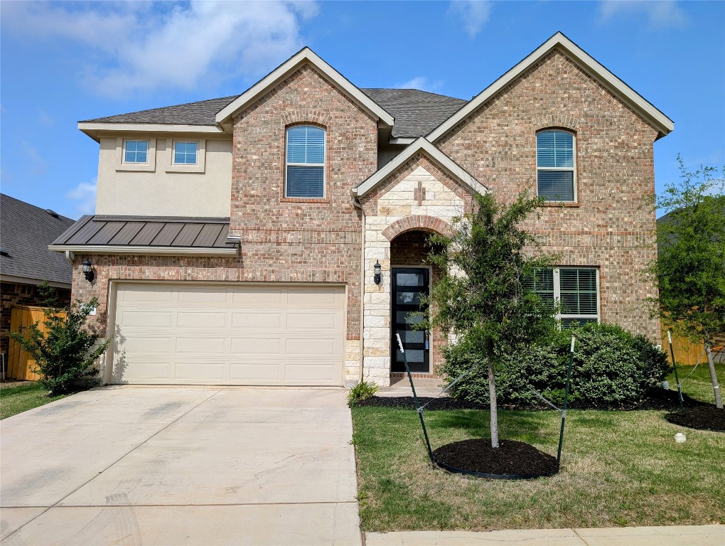 a front view of house with a yard and trees