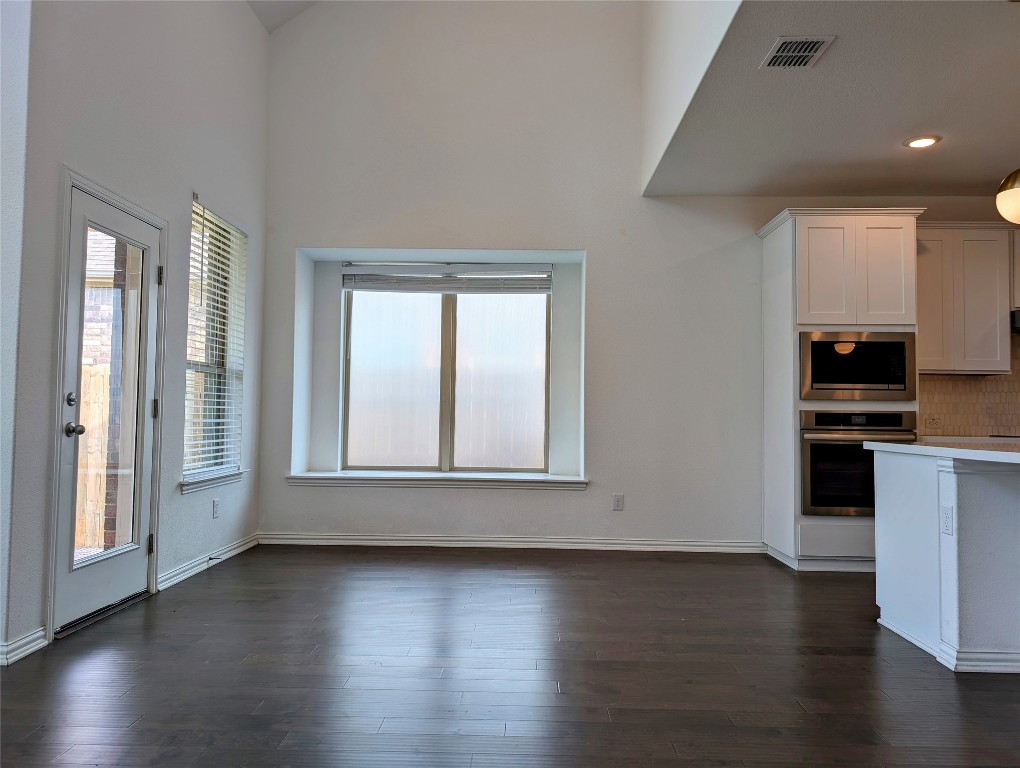 1344 Ridge Runner Drive Georgetown, TX 78628 - Photo 11 of 37 an empty room with wooden floor and windows
