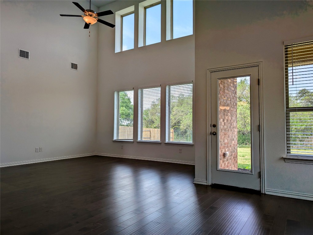 1344 Ridge Runner Drive Georgetown, TX 78628 - Photo 12 of 37 a view of an empty room with wooden floor and a window