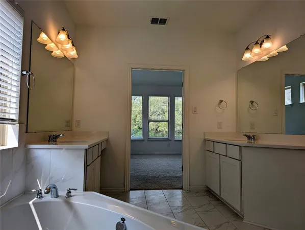a bathroom with a sink a vanity and a mirror