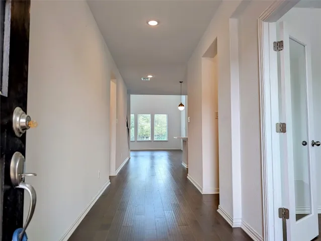 a view of a hallway with wooden floor