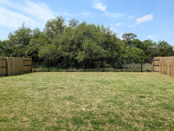 a backyard of a house with lots of green space