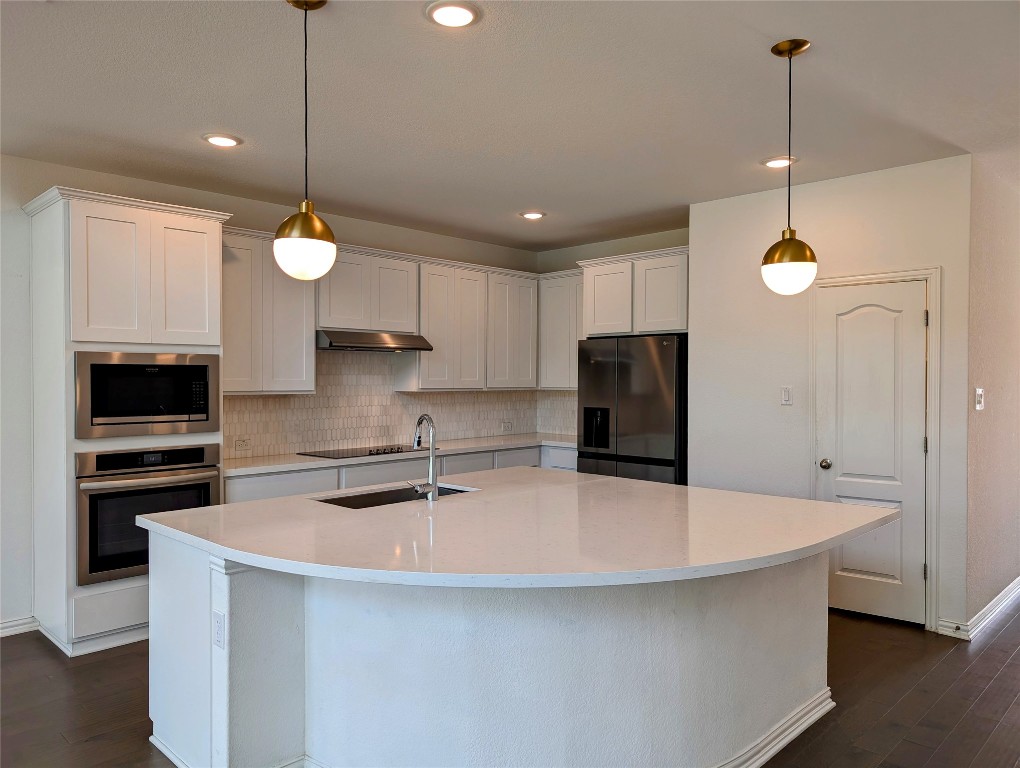 1344 Ridge Runner Drive Georgetown, TX 78628 - Photo 5 of 37 a kitchen with kitchen island a sink stainless steel appliances and cabinets